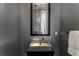 Stylish powder room featuring modern fixture, textured wallpaper, and elegant mirror at 3184 Wood Valley Nw Rd, Atlanta, GA 30327