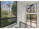 Staircase landing with large windows offering wooded views at 3184 Wood Valley Nw Rd, Atlanta, GA 30327