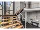 Open staircase with wood treads, stainless steel railings, and large windows at 3184 Wood Valley Nw Rd, Atlanta, GA 30327