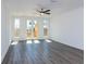 Bright bedroom featuring wood floors, three windows, and a ceiling fan at 344 Olmstead Way # 32, Alpharetta, GA 30022