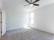 A bright bedroom featuring plush gray carpeting and a modern ceiling fan at 344 Olmstead Way # 32, Alpharetta, GA 30022