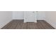 Hallway featuring wood-look flooring, white baseboards, and neutral walls at 344 Olmstead Way # 32, Alpharetta, GA 30022