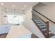 Bright hallway with staircase, light-colored wood floors, and white walls leading to the living areas at 344 Olmstead Way # 32, Alpharetta, GA 30022