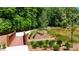 Scenic view of a pond and a wooded walking path with a small bridge in a beautiful community at 344 Olmstead Way # 32, Alpharetta, GA 30022
