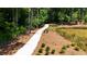Curving walking path with mulched side areas for landscaping near the pond in the community at 344 Olmstead Way # 32, Alpharetta, GA 30022