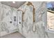 Large walk-in shower with marble walls and rainfall shower heads at 310 Hillcrest View Dr, Suwanee, GA 30024