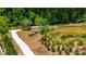 Aerial view of walking path with grasshopper sculpture and scenic pond surrounded by lush greenery at 348 Olmstead Way # 30, Alpharetta, GA 30022