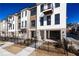 Charming townhome featuring a modern facade, complemented by black trim, a gated yard, and manicured landscaping at 348 Olmstead Way # 30, Alpharetta, GA 30022