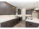 Modern kitchen boasts stainless steel appliances, white countertops, and dark wood cabinets at 348 Olmstead Way # 30, Alpharetta, GA 30022
