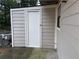 Attached storage shed with beige siding and white trim and door at 300 Flagstone Way, Austell, GA 30168