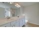 Bathroom with double vanity sinks, white cabinets, and a large mirror at 200 Sanctuary Dr, Mcdonough, GA 30253