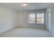 Bedroom with neutral carpet, a window for natural light, and a closet at 200 Sanctuary Dr, Mcdonough, GA 30253