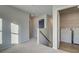 Carpeted upstairs hallway leading to a laundry room with new washer and dryer at 200 Sanctuary Dr, Mcdonough, GA 30253