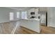 Modern kitchen featuring a center island, stainless steel appliances, and hardwood floors, with abundant natural light at 200 Sanctuary Dr, Mcdonough, GA 30253