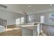 Bright living room with hardwood floors, modern fixtures, and a seamless transition to the kitchen, perfect for entertaining at 200 Sanctuary Dr, Mcdonough, GA 30253