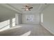 Spacious main bedroom with tray ceiling, ceiling fan, and abundant natural light at 200 Sanctuary Dr, Mcdonough, GA 30253
