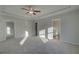 Bright main bedroom featuring a tray ceiling, fan, and an en-suite bathroom at 200 Sanctuary Dr, Mcdonough, GA 30253