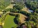 An elevated view shows a well-maintained community with open green spaces, a pond, and recreational facilities at 3971 Wolcott Cir # 3971, Atlanta, GA 30340