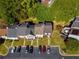 An aerial view reveals a neat row of townhomes, tidy lawns, and designated parking spots, all within a green setting at 3971 Wolcott Cir # 3971, Atlanta, GA 30340