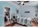 Bedroom with blue walls, bed, bathroom entrance, and wood floors at 3971 Wolcott Cir # 3971, Atlanta, GA 30340
