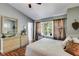 Comfortable bedroom with wood floors, neutral walls, dresser, and view to yard at 3971 Wolcott Cir # 3971, Atlanta, GA 30340