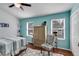 Bedroom with wood floors, blue walls, closet, chair, and outside view at 3971 Wolcott Cir # 3971, Atlanta, GA 30340