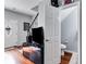 Hallway featuring hardwood floors leading to a half bath, with a TV area at 3971 Wolcott Cir # 3971, Atlanta, GA 30340