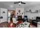 Open-concept living room with fireplace, hardwood floors, and access to dining area at 3971 Wolcott Cir # 3971, Atlanta, GA 30340