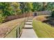 Outdoor walkway going up a small hill with fence and trees surrounding at 3971 Wolcott Cir # 3971, Atlanta, GA 30340