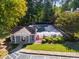 Aerial view of a community pool area with a clubhouse and fenced-in pool at 3971 Wolcott Cir # 3971, Atlanta, GA 30340