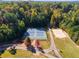 Aerial view of tennis courts and a sand volleyball court surrounded by trees at 3971 Wolcott Cir # 3971, Atlanta, GA 30340