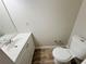 Half bathroom featuring vinyl floors, standard toilet and vanity sink at 3589 Main Station Sw Dr, Marietta, GA 30008