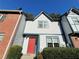 Inviting townhome with a stucco facade, tidy shrubs, and a striking red front door at 3589 Main Station Sw Dr, Marietta, GA 30008