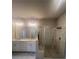 Primary bathroom featuring a double sink vanity, a glass shower, and tile floors at 273 Lakeside Pl, Canton, GA 30114