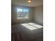 Bedroom with a large window letting in natural light and a carpeted floor at 273 Lakeside Pl, Canton, GA 30114
