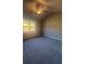 Comfortable carpeted bedroom with a ceiling fan and large window at 273 Lakeside Pl, Canton, GA 30114