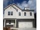 Beautiful two-story home with a stone accent and white siding, showcasing curb appeal at 273 Lakeside Pl, Canton, GA 30114