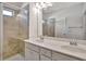 A well-lit bathroom featuring a double sink vanity, modern fixtures, and a walk-in shower with glass doors at 1813 Hislop Ln, Atlanta, GA 30345