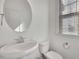 A bathroom featuring a sleek white sink, toilet, and a modern mirror with natural light at 1813 Hislop Ln, Atlanta, GA 30345