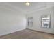 Bedroom featuring tray ceilings, neutral carpet, and windows with wood blinds at 1813 Hislop Ln, Atlanta, GA 30345