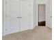 Bedroom featuring plush carpet, closet with panel doors, and entry to a hall at 1813 Hislop Ln, Atlanta, GA 30345