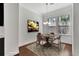 Bright staged dining area featuring hardwood floors, large windows, and modern lighting fixture at 1813 Hislop Ln, Atlanta, GA 30345