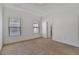 A spacious carpeted room with neutral walls, windows with blinds, and ample natural light, ready for customization at 1813 Hislop Ln, Atlanta, GA 30345