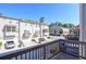 An exterior view from the balcony showing well-maintained townhomes, manicured landscaping, and a clear blue sky at 1813 Hislop Ln, Atlanta, GA 30345