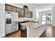 Bright kitchen with stainless steel refrigerator, granite countertops and wood flooring at 1813 Hislop Ln, Atlanta, GA 30345