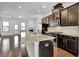 Modern kitchen features stainless steel appliances, dark cabinetry, and a spacious granite island at 1813 Hislop Ln, Atlanta, GA 30345