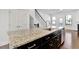 Kitchen island has stainless dishwasher and sink, complemented by brown cabinets at 1813 Hislop Ln, Atlanta, GA 30345