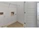Bright laundry room featuring utility hook-ups and a white paneled door at 1813 Hislop Ln, Atlanta, GA 30345