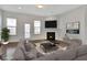 Staged living room with fireplace and kitchen view at 1813 Hislop Ln, Atlanta, GA 30345