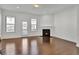 Spacious living room with hardwood floors, fireplace, and natural light from windows and glass door at 1813 Hislop Ln, Atlanta, GA 30345